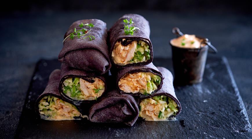 Black shawarma with chicken, cabbage and cucumber salad and spicy sauce
