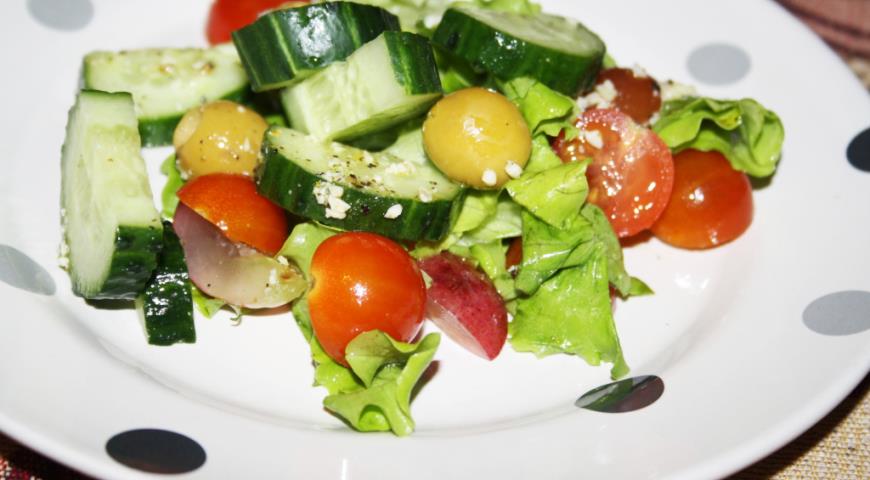 Bright vegetable salad with red grapes