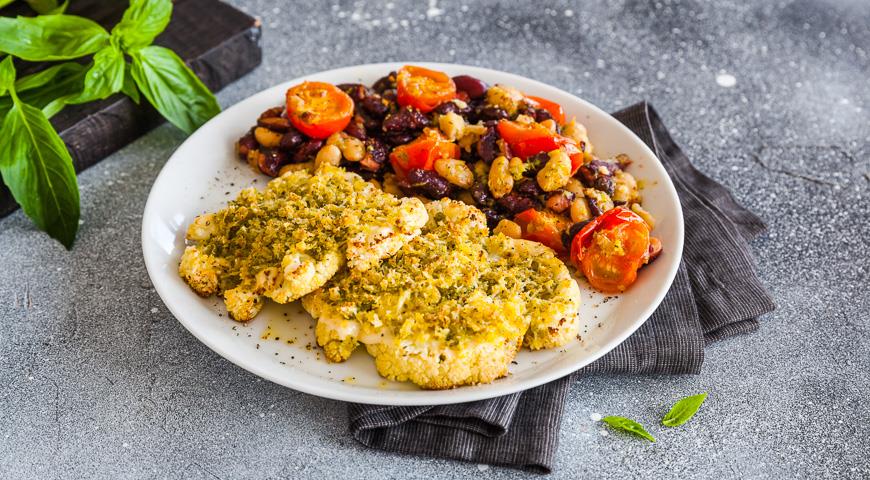 Cauliflower steak with crispy pesto with beans and tomatoes