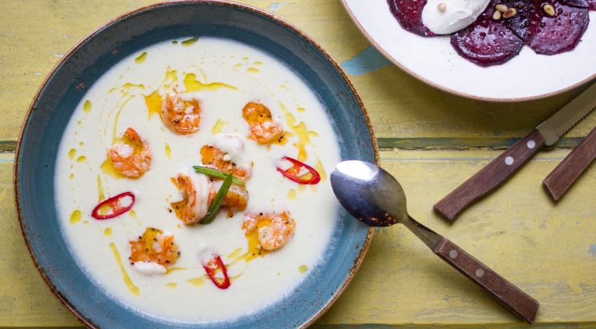 Creamy celery soup with shrimps and truffle aroma