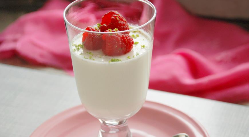 Creamy panna cotta with pickled raspberries in a glass