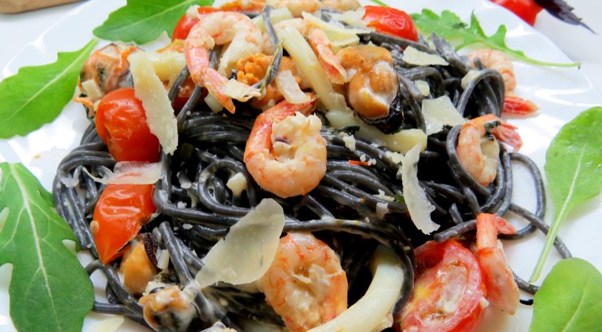 Cuttlefish ink pasta with seafood in a creamy sauce