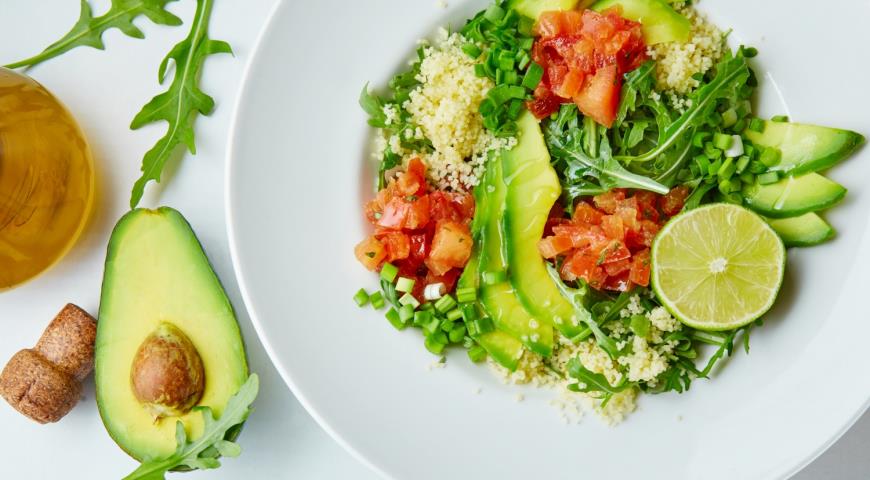 Light salad with avocado, spicy tomatoes and couscous