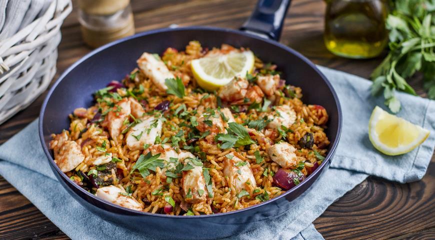 Paella - Spanish rice dish with white fish and vegetables