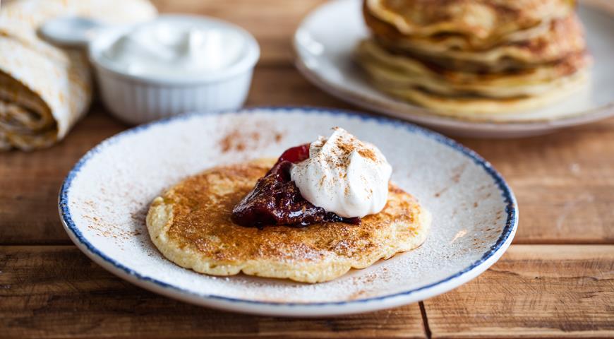 Pancakes with plum jam and whipped cream