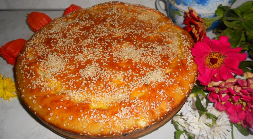 Pie with cabbage and meat with sesame sprinkles