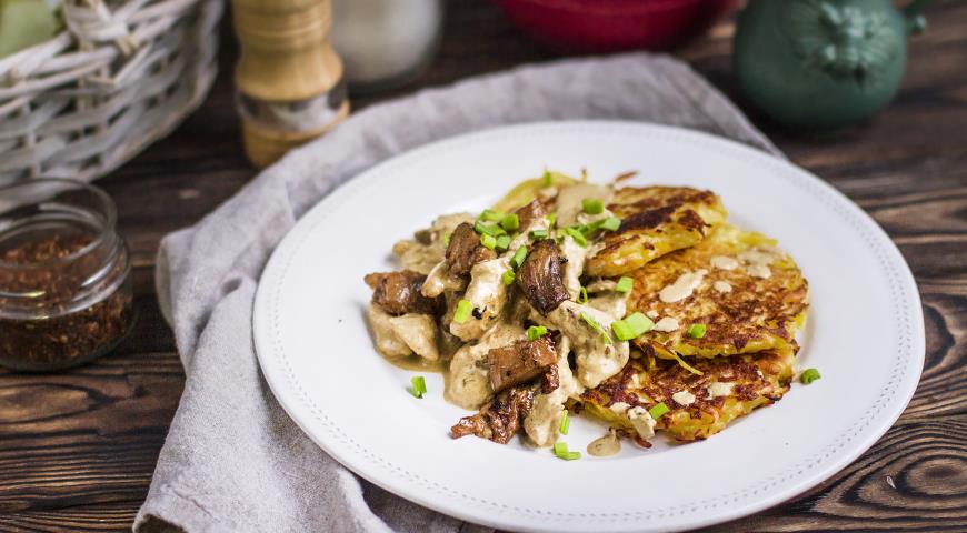 Potato pancakes with chicken and mushrooms in a creamy sauce