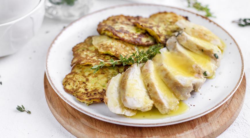 Zucchini pancakes with chicken fillet and orange sauce